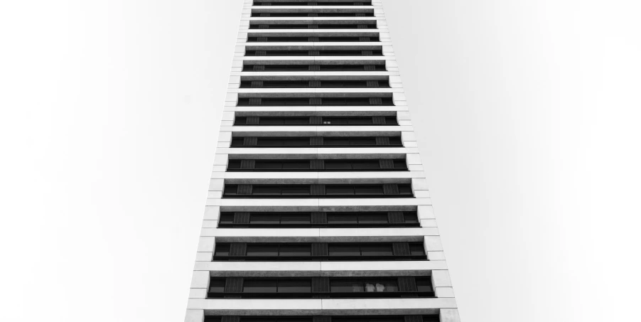 the bottom of a tall building with balconies on each floor