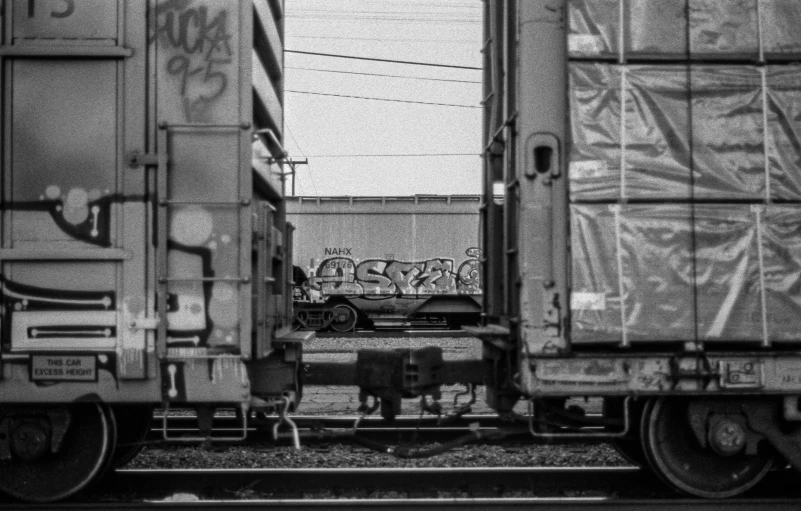 train tracks with graffiti on them in black and white