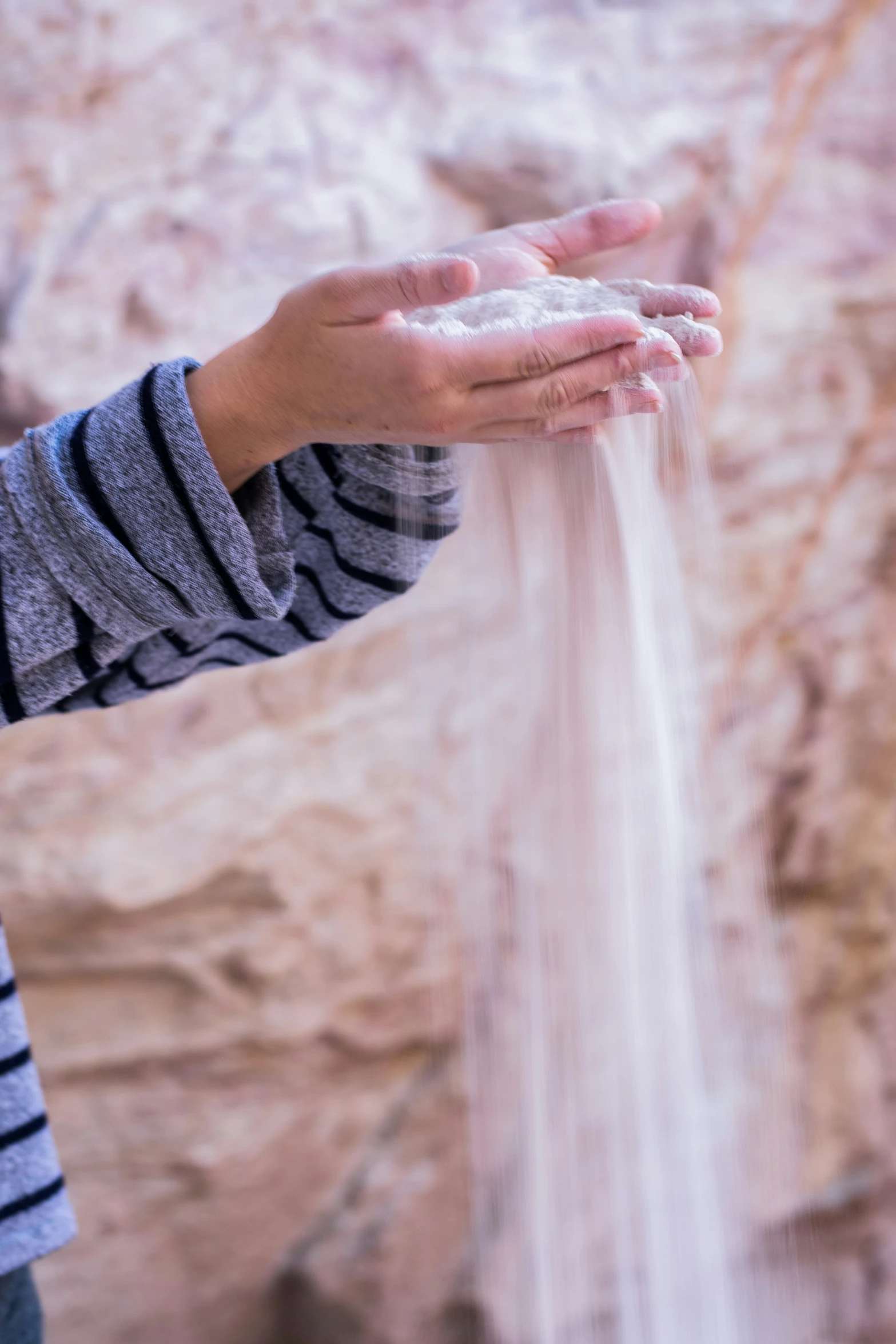 someone washing their hands in a stream of soap