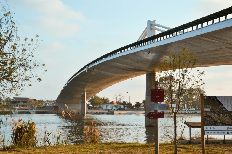 a bridge is over the water with traffic signs