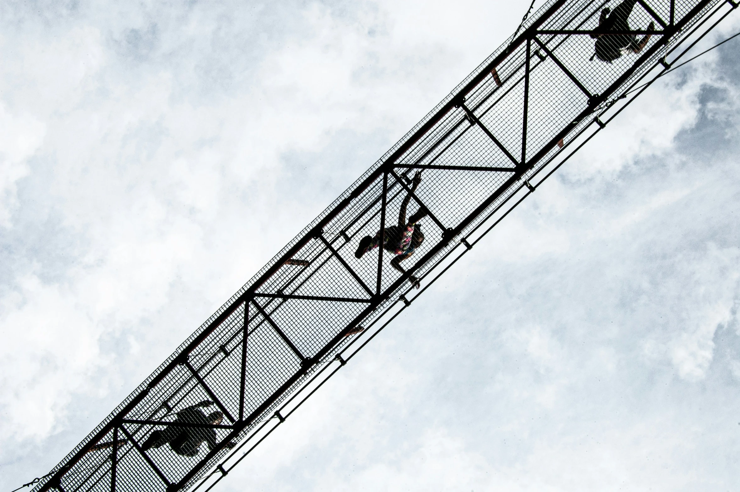 a ferris wheel is moving against the blue sky