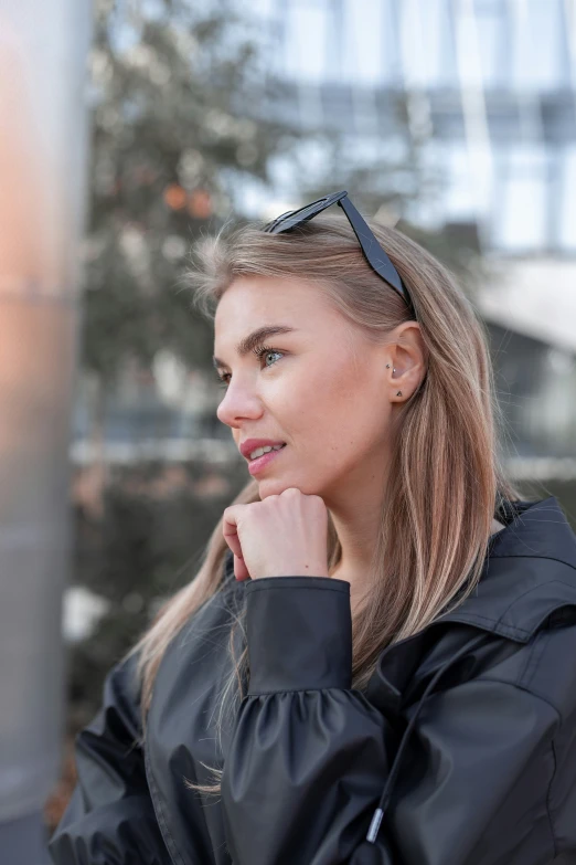 a woman looking away while wearing sunglasses