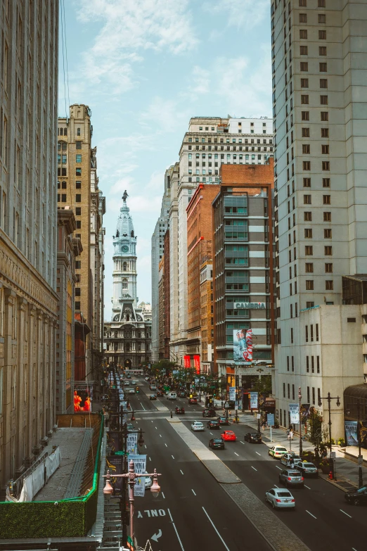 a busy city street with tall buildings on both sides of it