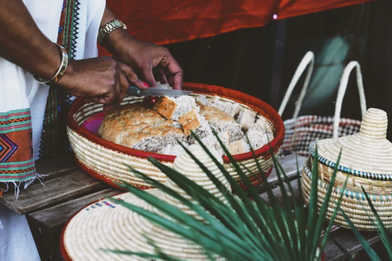 a woman  bread in a red basket