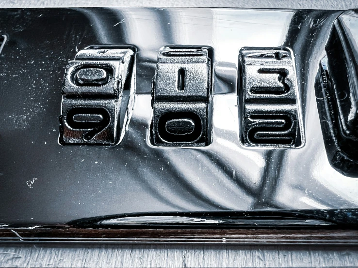 a metal steel wall is shown with some type of letters