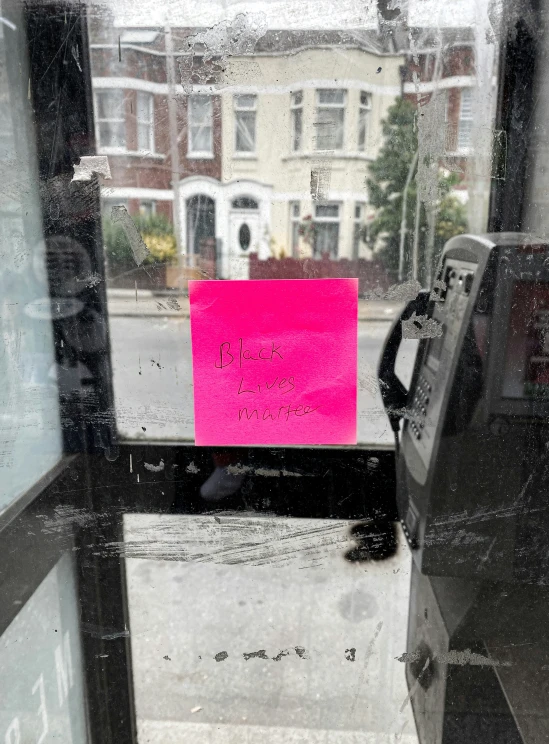 a window with the reflection of houses in it