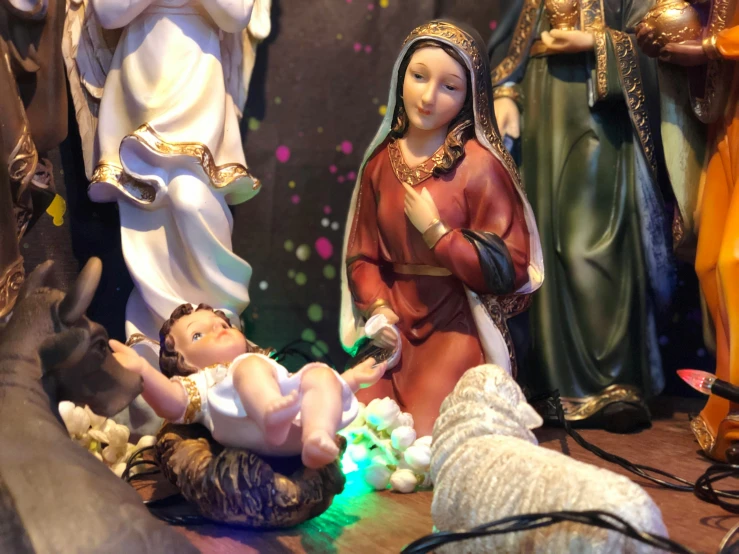 the nativity scene includes four figurines of jesus and his family