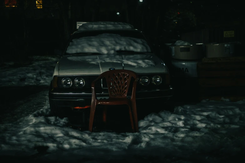 a chair that is sitting near a car