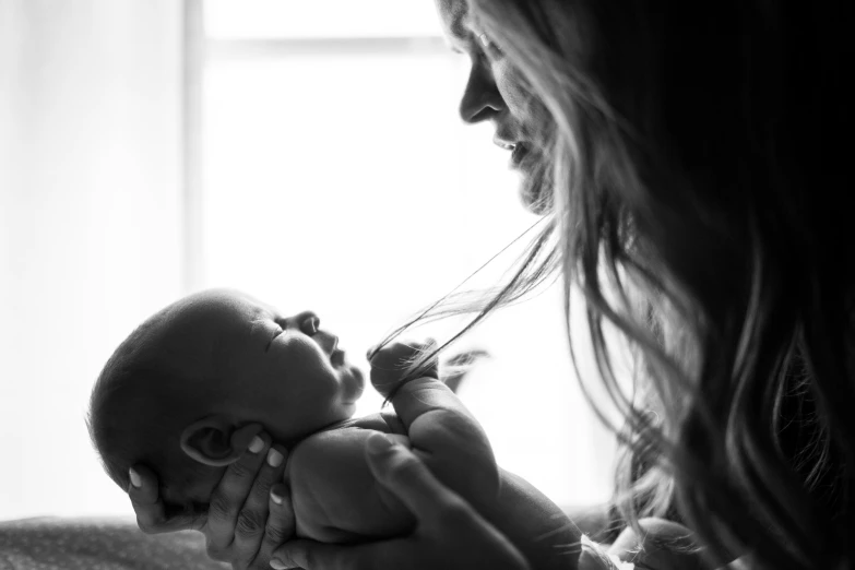 a woman holding a baby in her arms