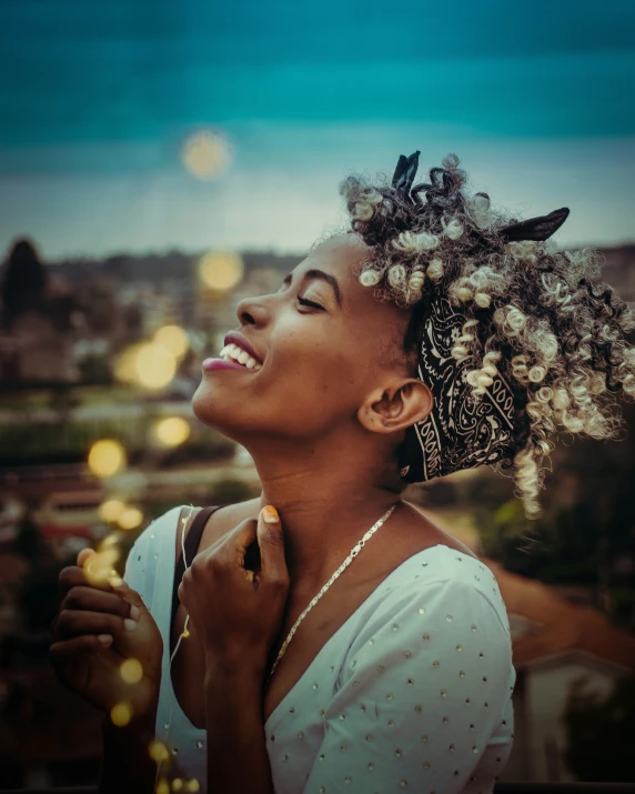 a woman with a white top is smiling and looking up