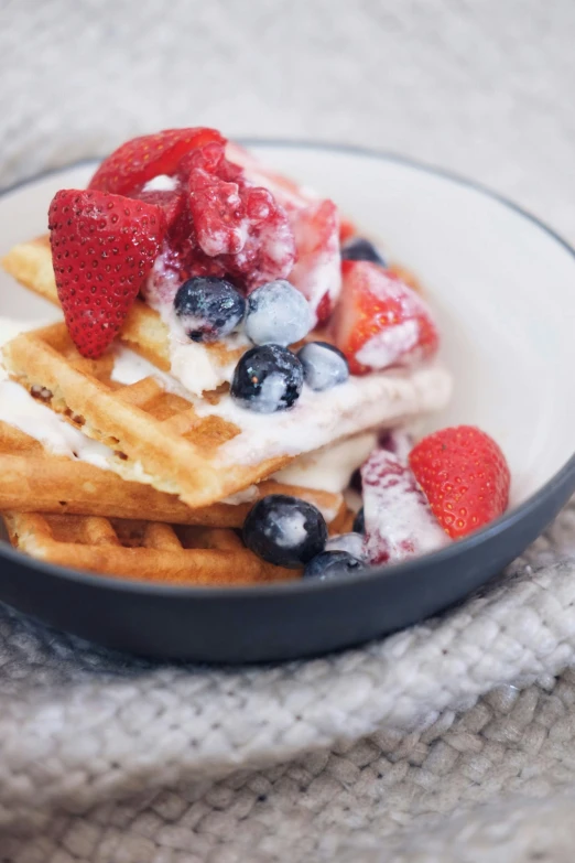 pancakes with ice cream and fresh berries are on a plate