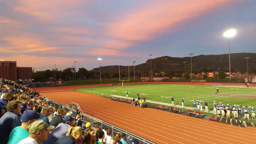 a stadium full of people standing on top of a field