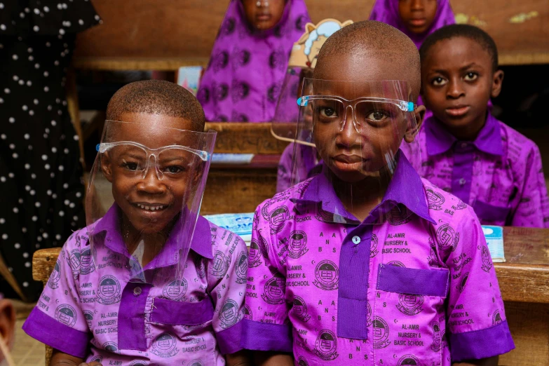 three children in glasses standing next to each other