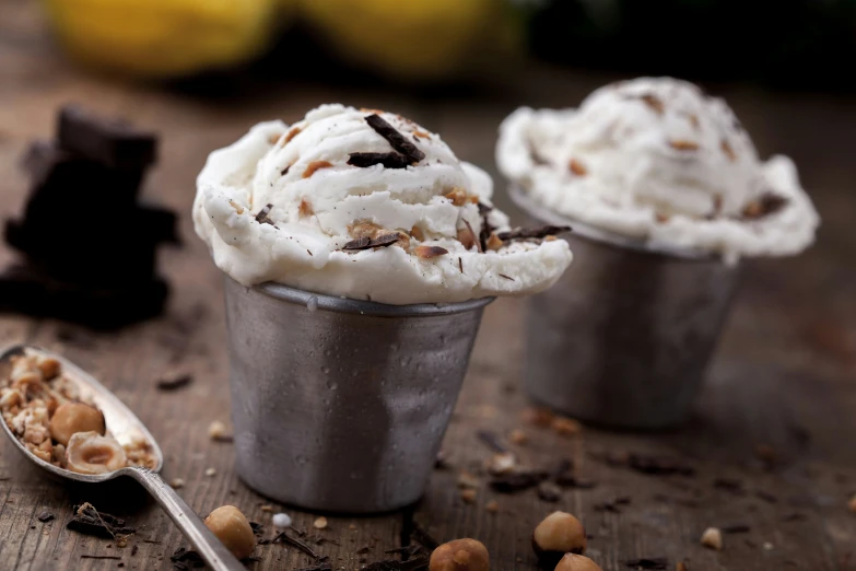 three silver cups filled with ice cream and toppings