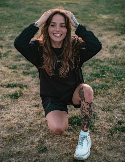 a girl posing for a po with her tattoos on