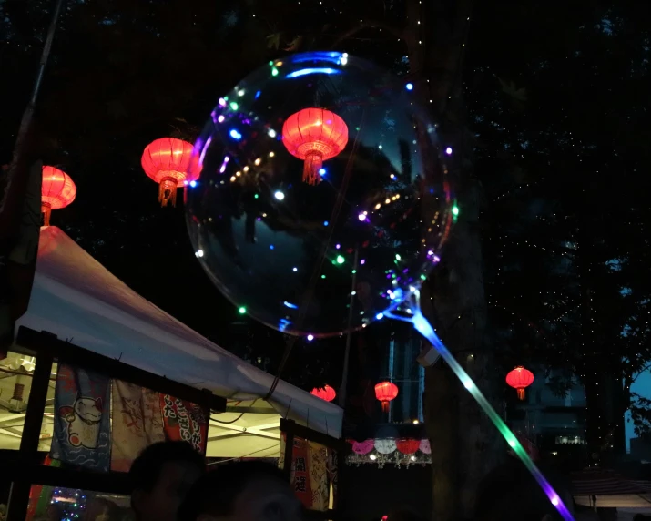 colorful lights shine inside a shiny glass bubble