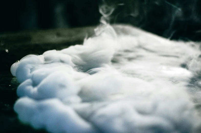 some white clouds that are flying across the ground