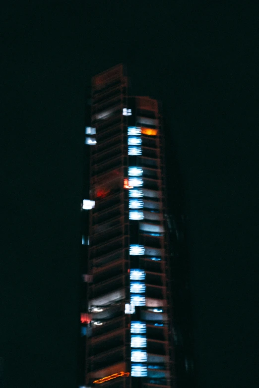 very high rise in the night sky illuminated with blur