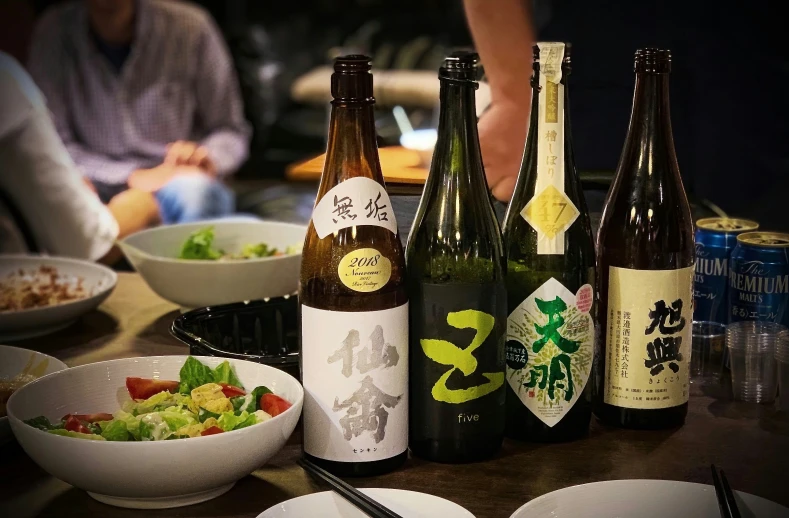 some bottles of beer some plates and chopsticks