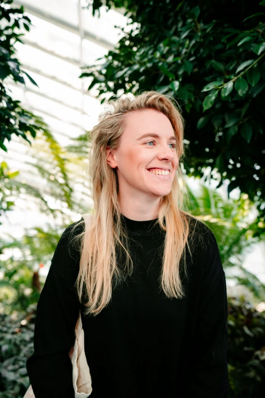 an image of woman in black sweater smiling