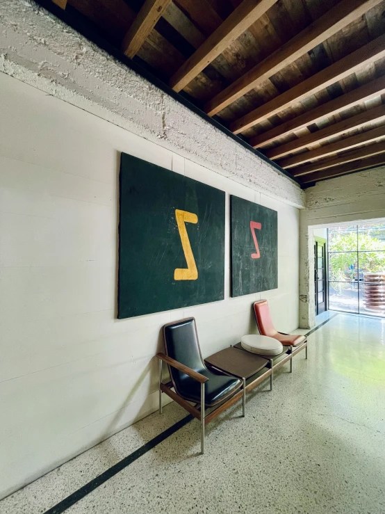 three signs advertise the entry to an industrial - style building