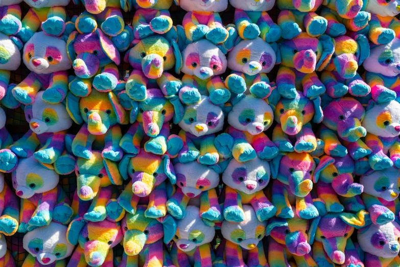 colorful teddy bears are arranged on the ground