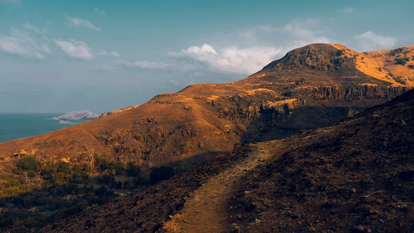 a road and steep hill in the desert