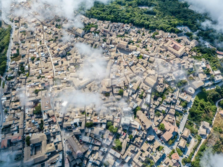 the aerial view shows a small town surrounded by fog