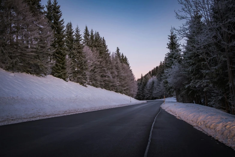 a person riding on a snow covered road