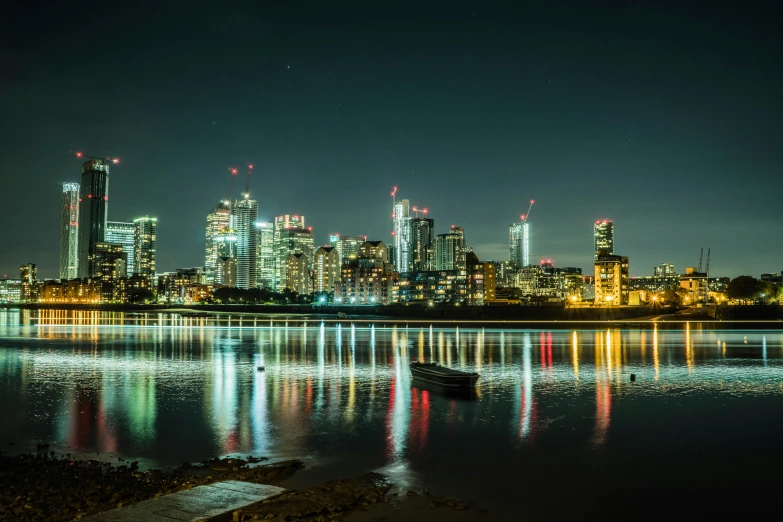 view of a city skyline at night from the water