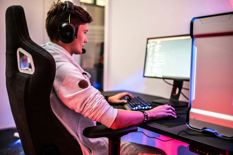 a man with headphones on working at a desk