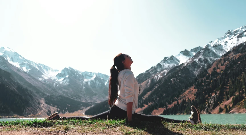 a woman on top of the mountain taking in some air time