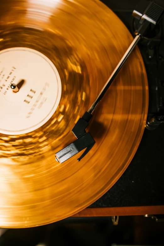 an old vinyl record with a gold and black record top