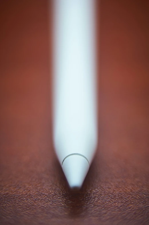 a single curved tip that is white on the surface