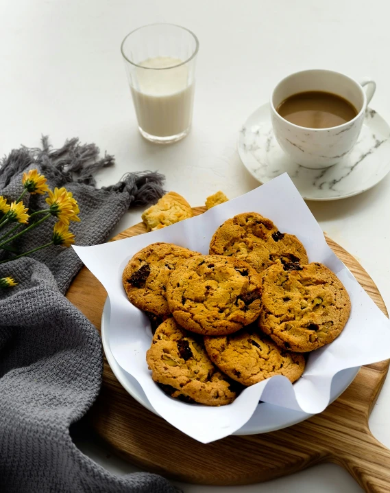 a plate of cookies next to a cup of coffee