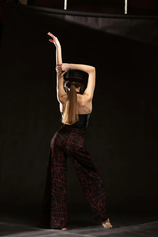 a woman is doing a back wheel trick on a stage