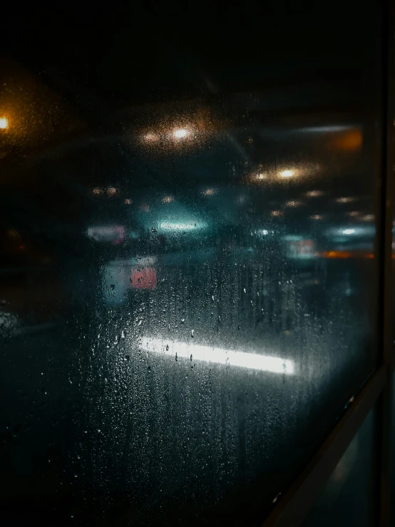 view through window of urban traffic at night time