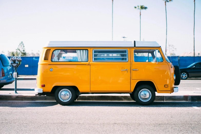 a small yellow van parked in a parking space