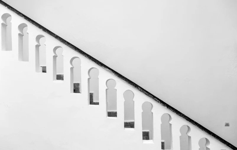 a man walking up an open air staircase