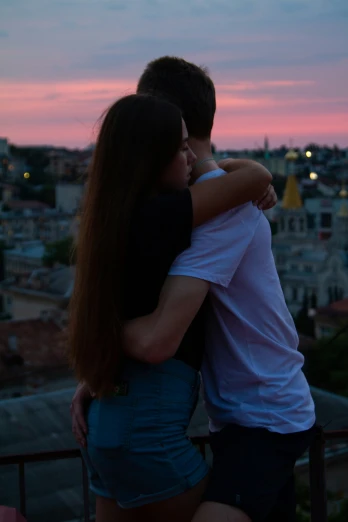 two people are emcing and the sunset is set behind them