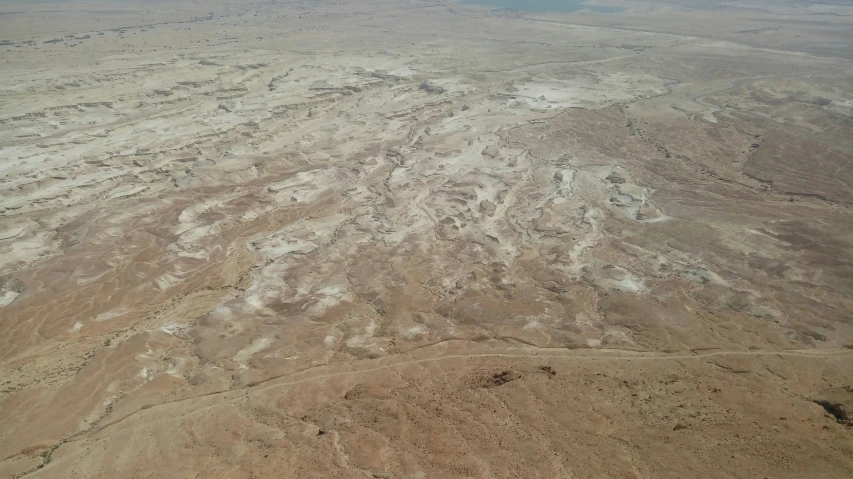the view out of an airplane window looking down at the desert land