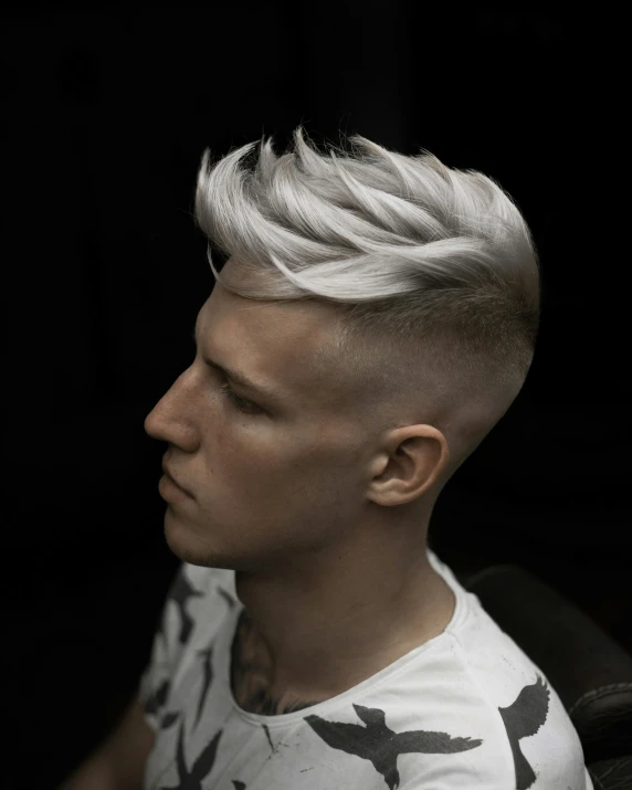 a man with a white haircut with silver highlights