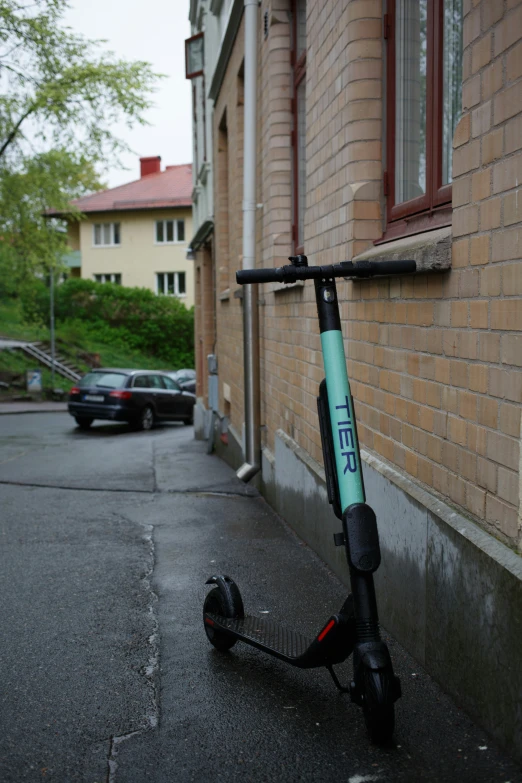 a scooter parked next to a brick building