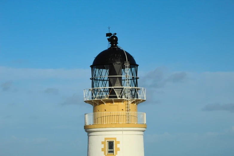 a light tower with several people on top