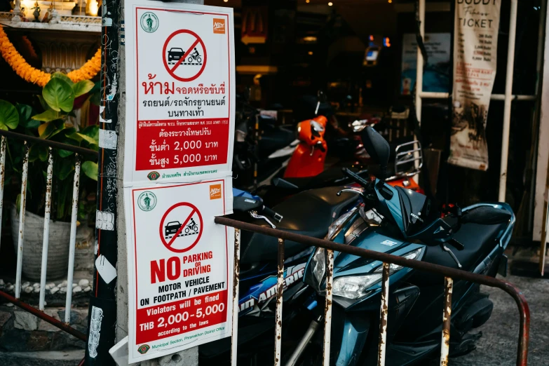 a sign in the middle of a motorcycle parked outside a building