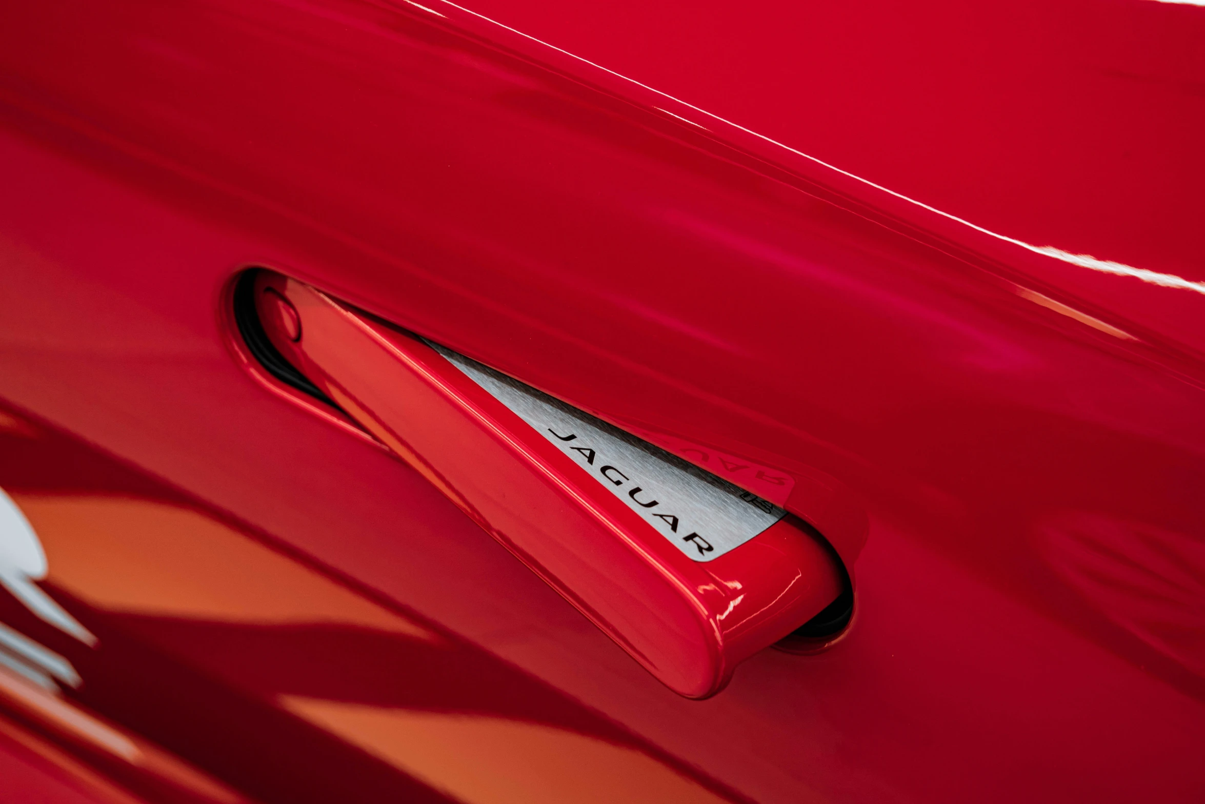 close up of door handle on a red car