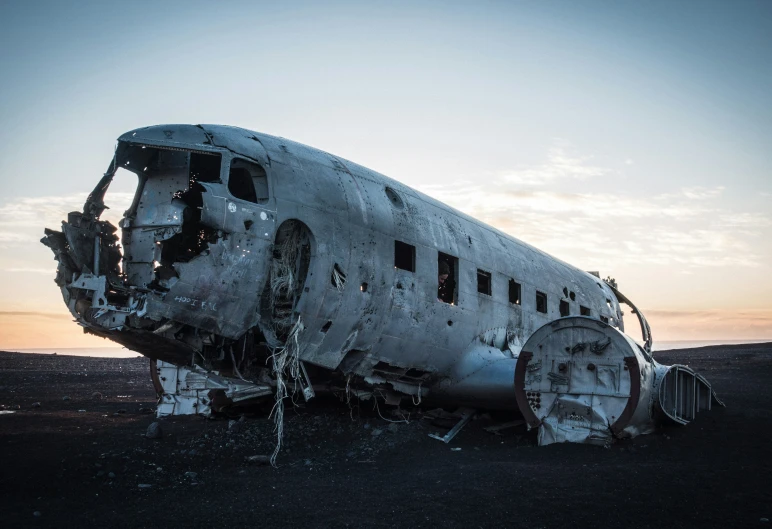 a large airplane sits in a field by itself