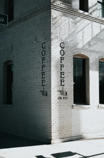 an empty building with a brick facade has words written on it
