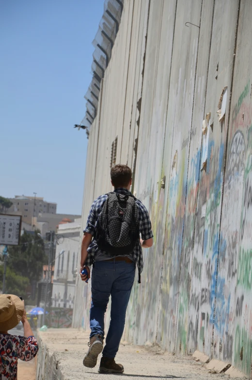 the man is walking down the street alone