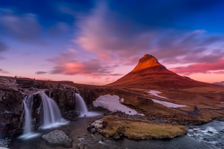 the mountain looks like a face with a waterfall